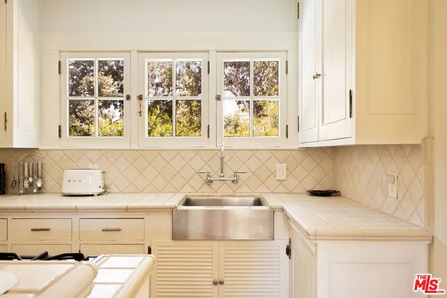 a bathroom with a sink and a window
