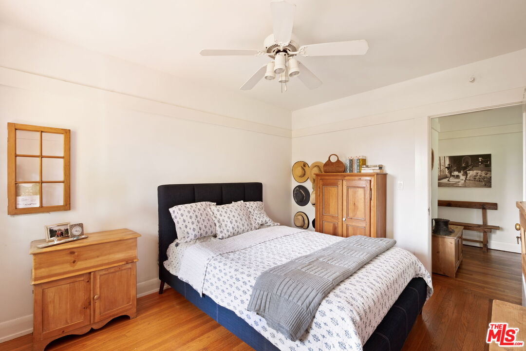 1205 Arden Road Pasadena, CA 91106 - Photo 21 of 24 a bedroom with a bed and wooden floor
