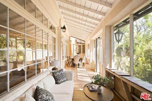 a living room with furniture and floor to ceiling windows