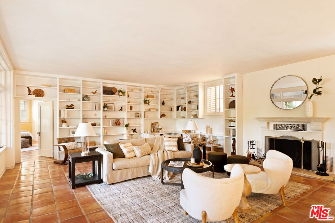 1205 Arden Road Pasadena, CA 91106 - Photo 6 of 24 a living room with furniture a fireplace and a flat screen tv