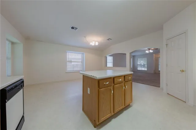 a view of entryway with kitchen island wooden floor and window