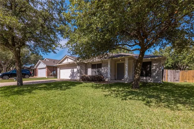 a house that has a tree in front of the house
