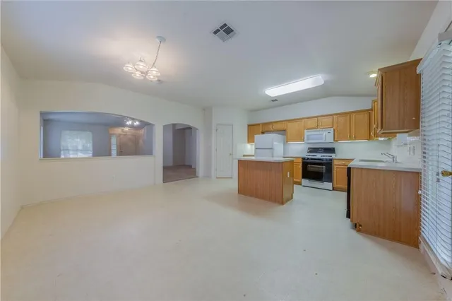 a kitchen with cabinets and window