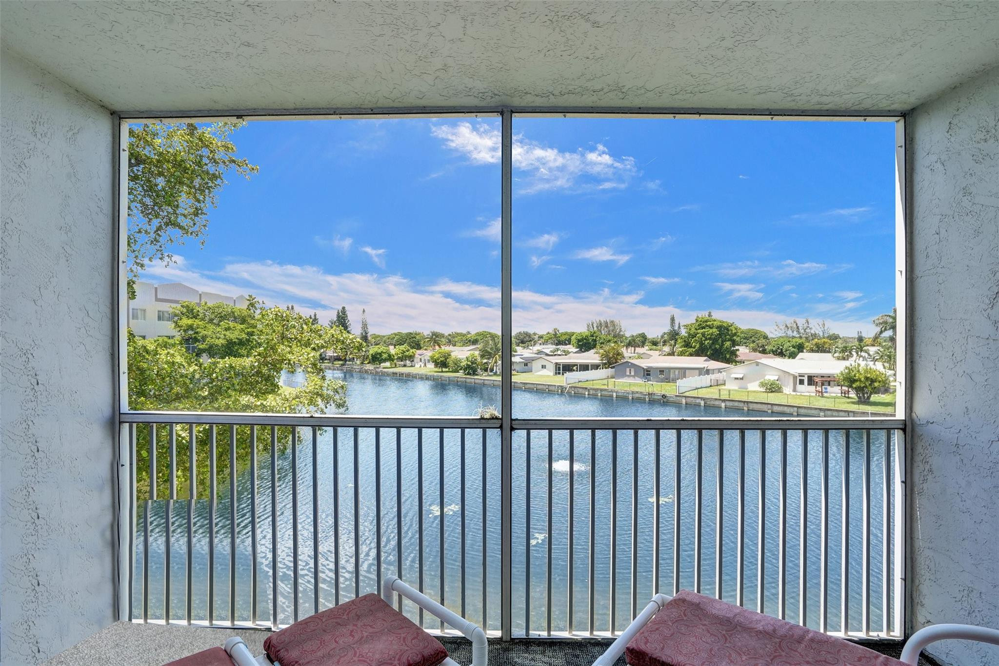 9575 Weldon Circle, Unit 305 Tamarac, FL 33321 - Photo 4 of 28 SPECTACULAR WIDE LAKE VIEW FROM PATIO