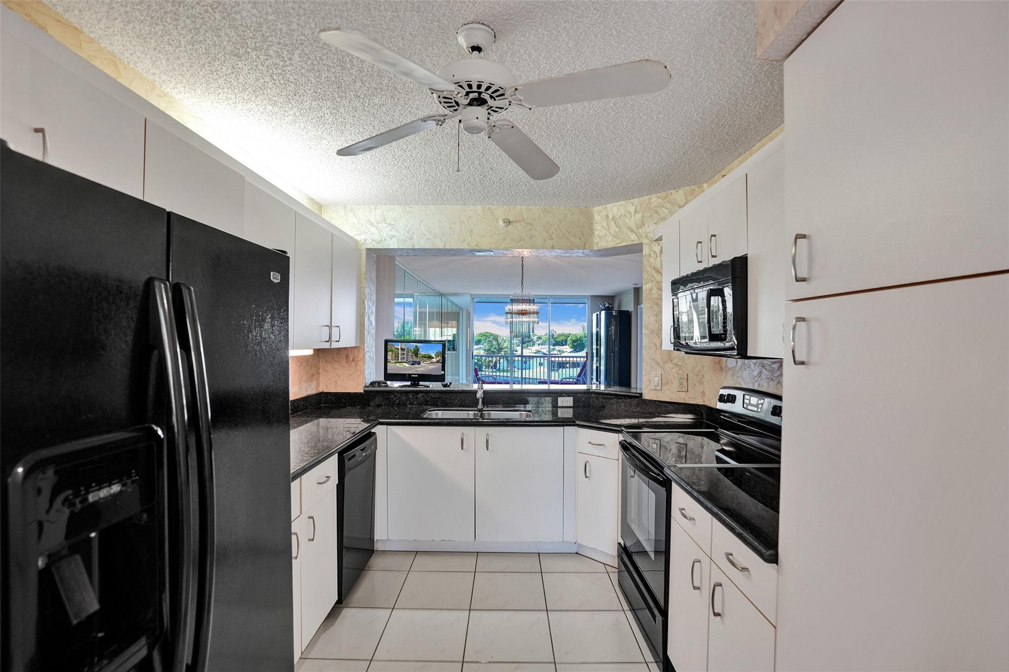 9575 Weldon Circle, Unit 305 Tamarac, FL 33321 - Photo 7 of 28 UPDATED KITCHEN W/GRANITE COUNTERTOPS