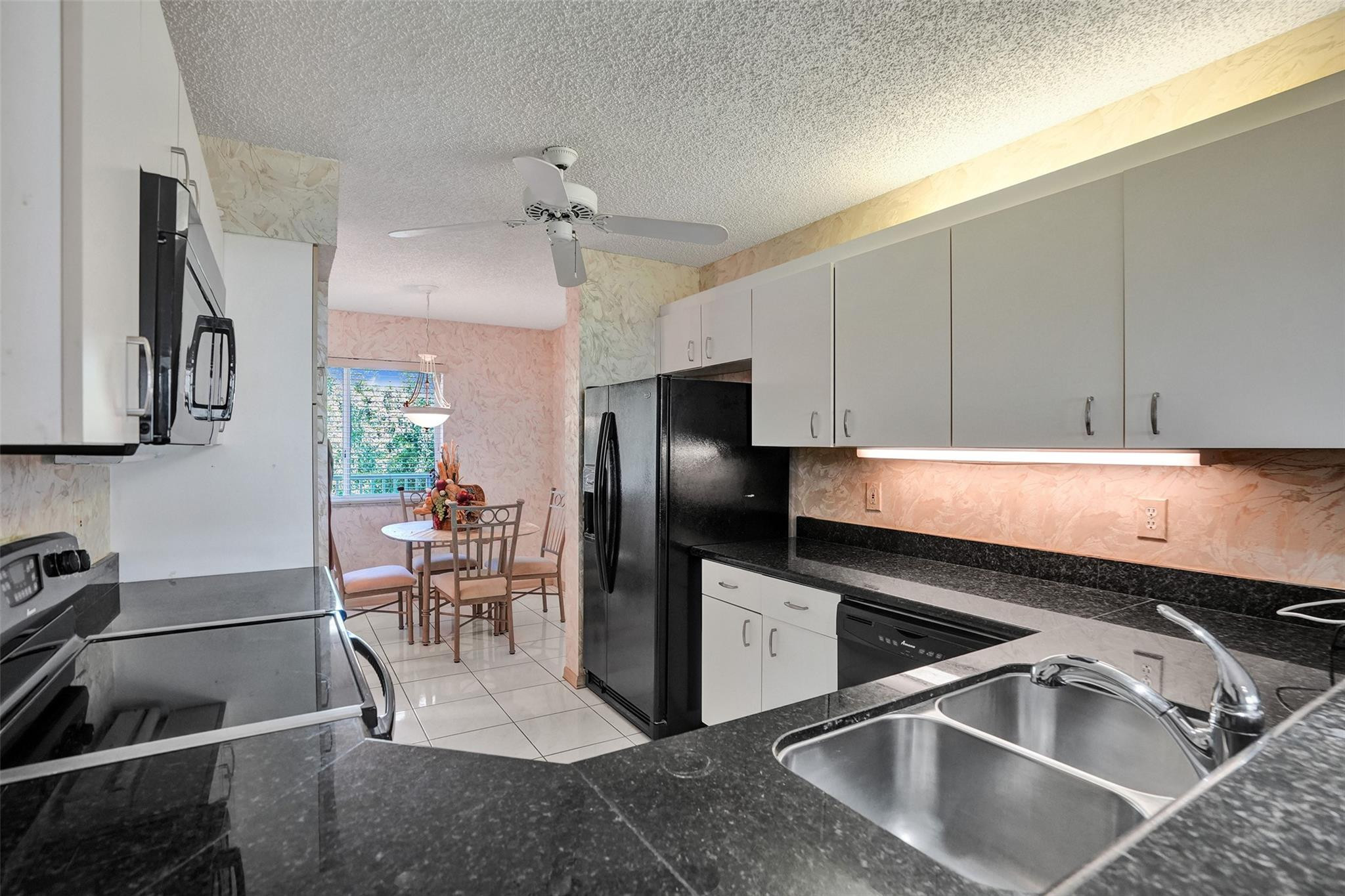 9575 Weldon Circle, Unit 305 Tamarac, FL 33321 - Photo 8 of 28 BRIGHT & SPACIOUS EAT IN KITCHEN