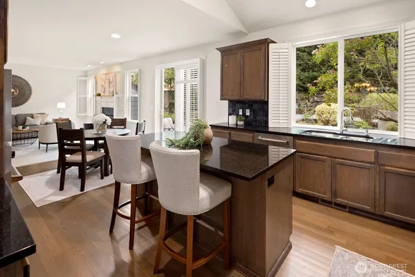 a kitchen with a table chairs and wooden floor