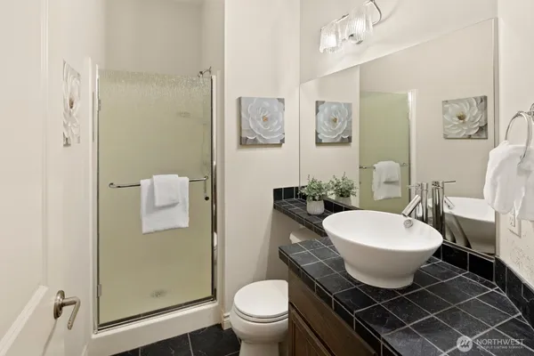 a spacious bathroom with a toilet a sink and a shower