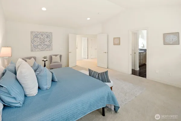 a spacious bedroom with a bed and window