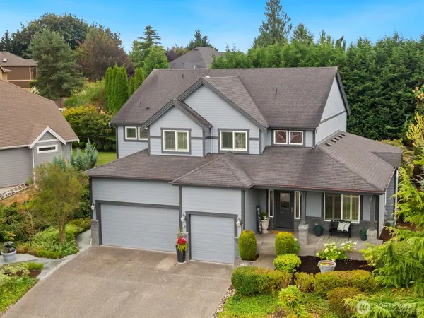 a aerial view of a house with yard and green space
