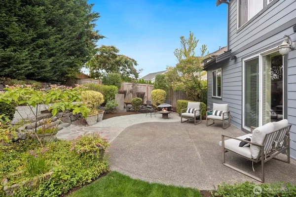 a view of a patio with table and chairs and potted plants