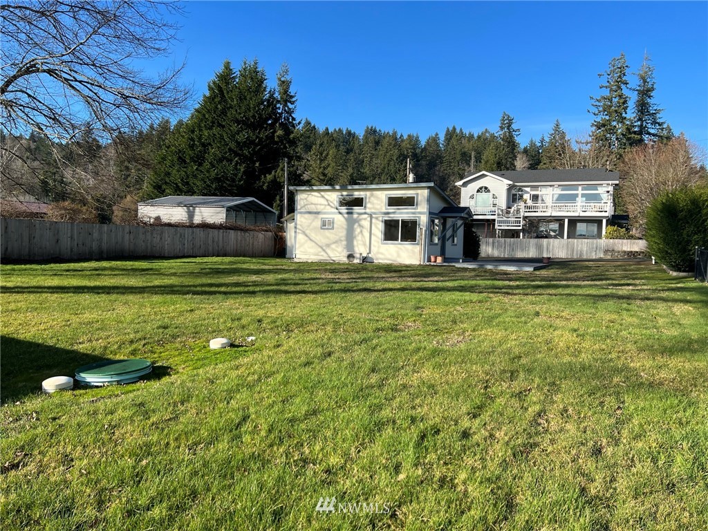 160 Northeast Wagon Wheel Road Belfair, WA 98528 - Photo 23 of 25 a front view of a house with a garden
