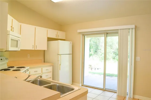 a kitchen with a refrigerator a stove and a cabinets
