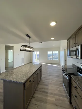 a view of kitchen and hall with wooden floor