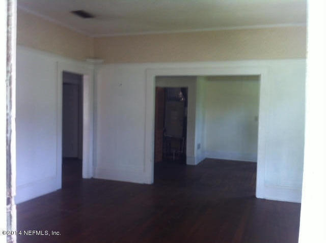 2017 Huntsford Road Jacksonville, FL 32207 - Photo 3 of 20 an empty room with wooden floor and windows