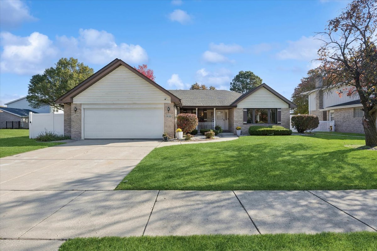 18311 Holland Road Lansing, IL 60438 - Photo 2 of 19 a front view of a house with a yard
