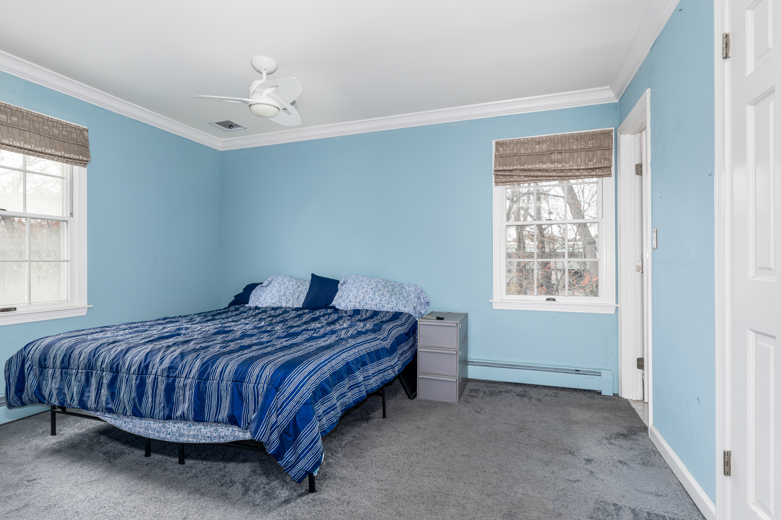 224 Roses Mill Road Milford, CT 06460 - Photo 12 of 30 a bed sitting in a bedroom next to a window