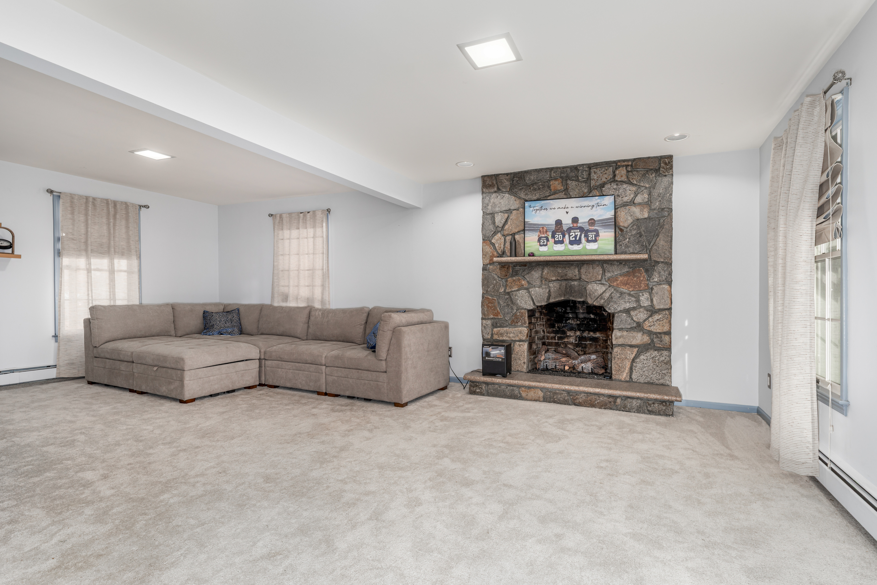 224 Roses Mill Road Milford, CT 06460 - Photo 18 of 30 a living room with furniture a fireplace and a flat screen tv