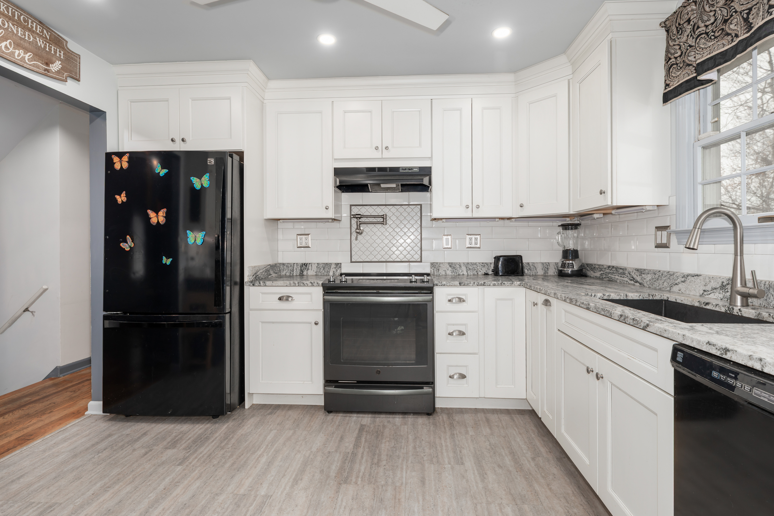 224 Roses Mill Road Milford, CT 06460 - Photo 5 of 30 a kitchen with a refrigerator stove and white cabinets