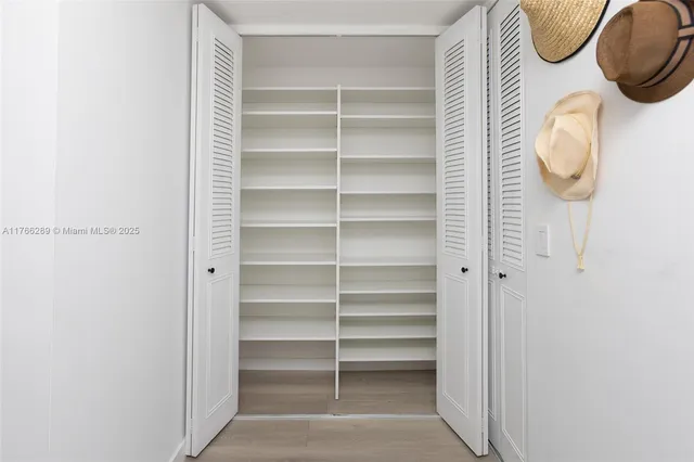 a spacious bedroom with a bed and a cabinets