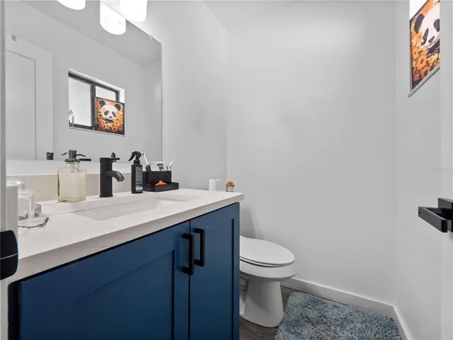 a bathroom with a sink mirror and toilet