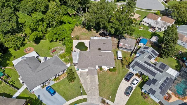an aerial view of a house with a yard basket ball court and outdoor seating
