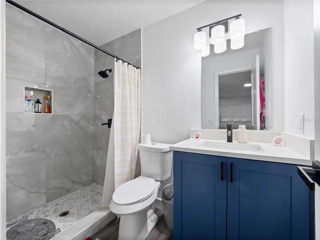 a bathroom with a sink toilet and shower