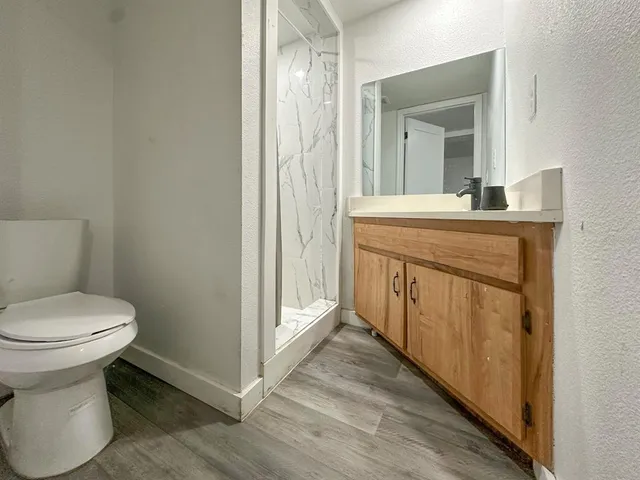 a bathroom with a sink a toilet and a mirror