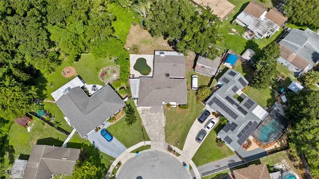 an aerial view of a house with outdoor space and a lake view