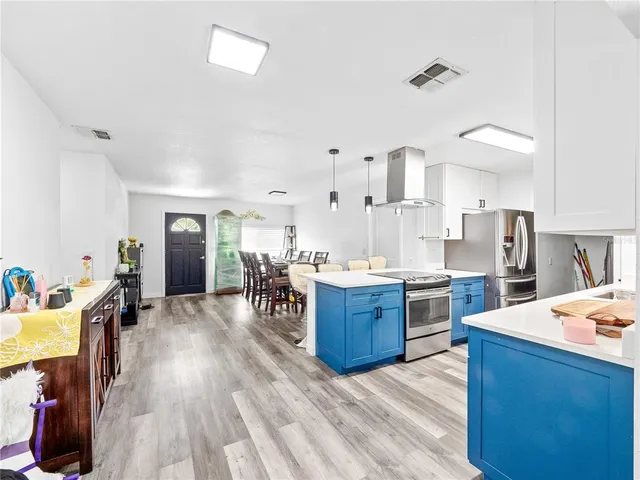 a large kitchen with sink cabinets and stainless steel appliances