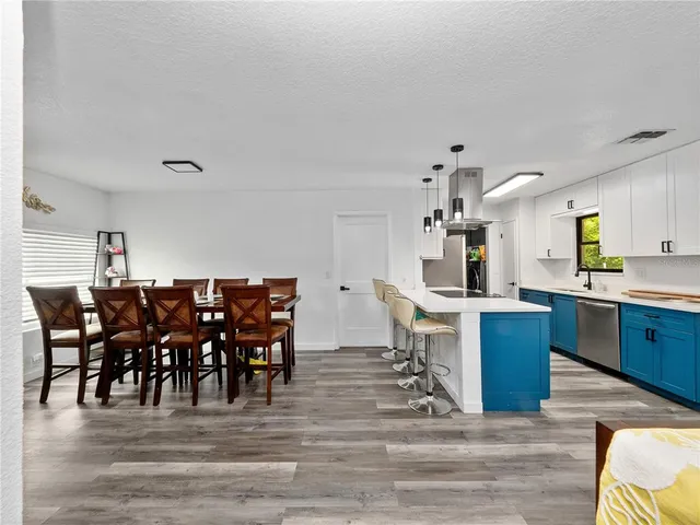 a large kitchen with a table and chairs