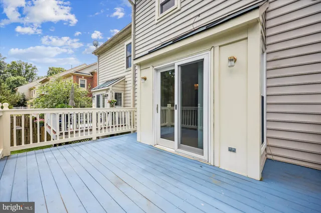 a view of deck with a large window and wooden floor