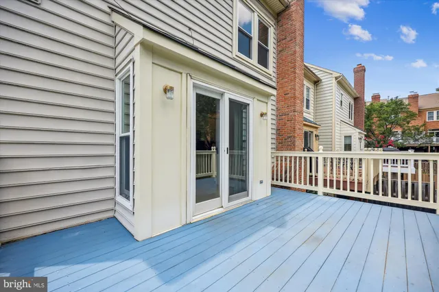 a view of a wooden deck besides a house