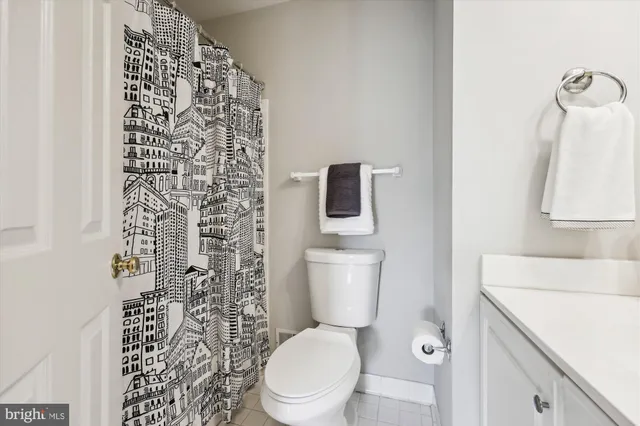 a white toilet sitting next to a shower curtain