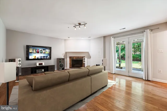 a living room with furniture a large window and a flat screen tv