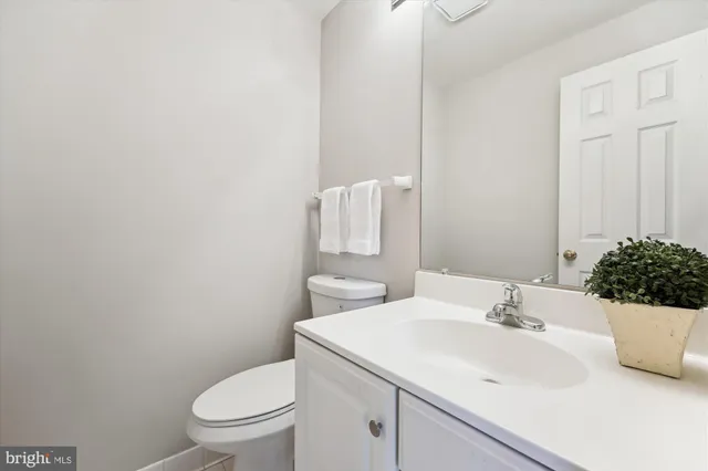 a bathroom with a sink a toilet and mirror