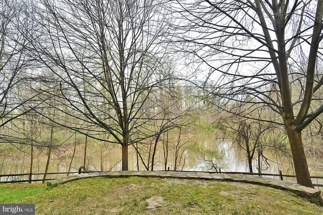 a front view of a building with cars parked