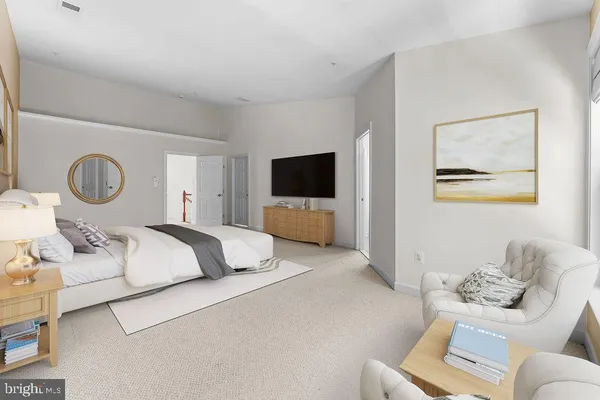 a bedroom with a large bed and a couch