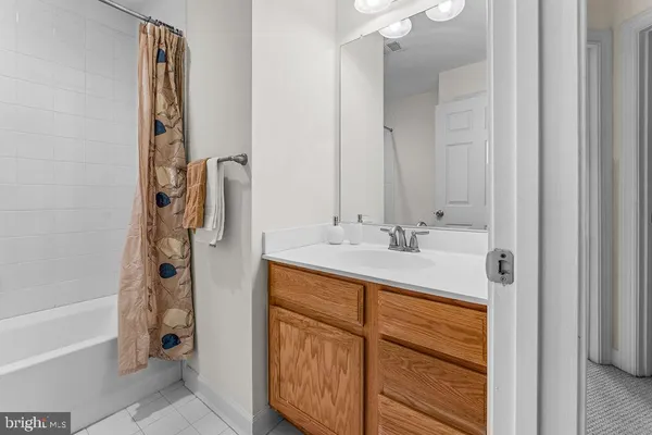 a bathroom with a double vanity sink a mirror and a bathtub
