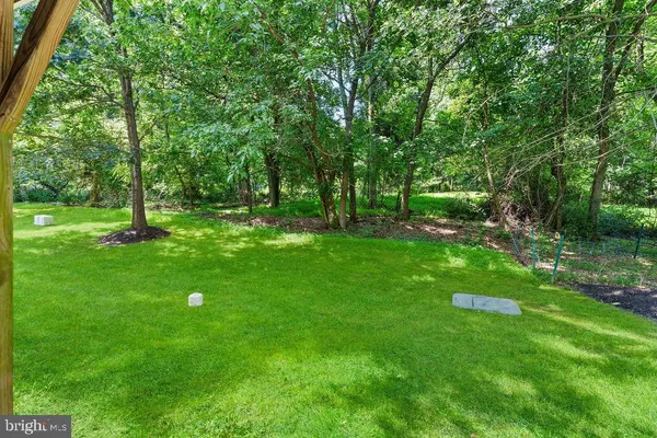 a green field with lots of trees in it