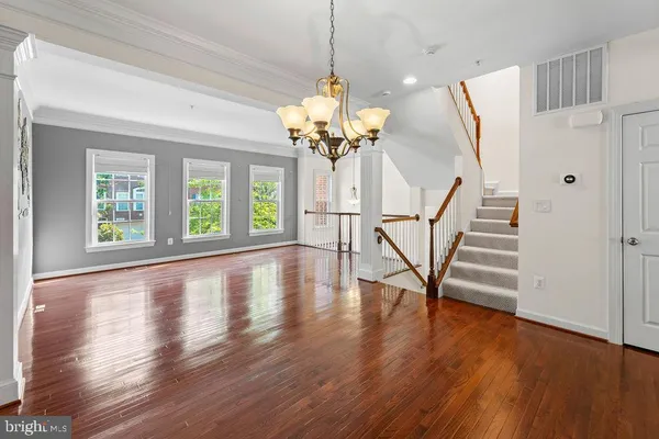 a view of a room with wooden floor and windows