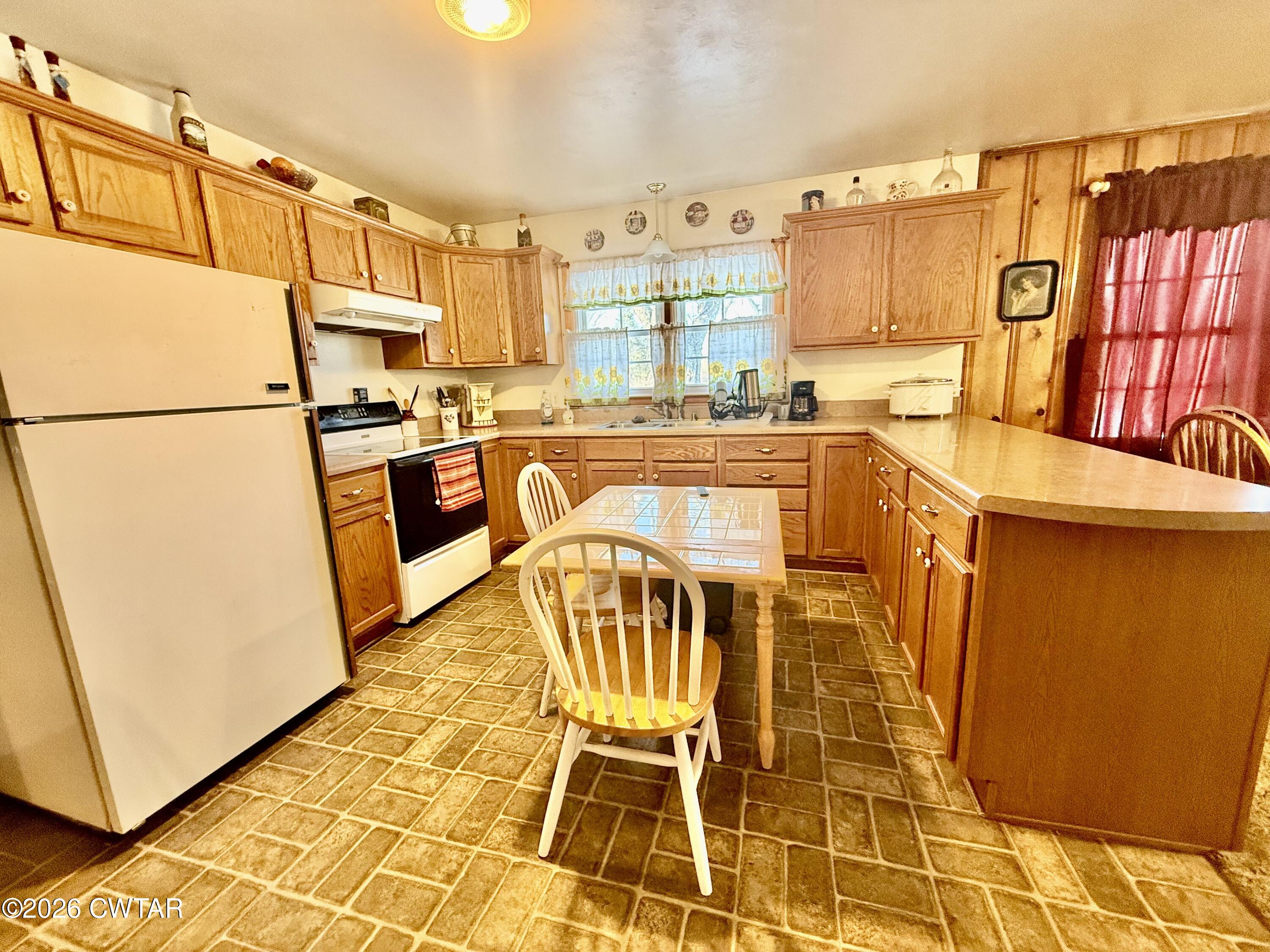 5389 Rives Mt Pelia Road Rives, TN 38253 - Photo 17 of 19 a kitchen with granite countertop a refrigerator a stove a sink and dishwasher