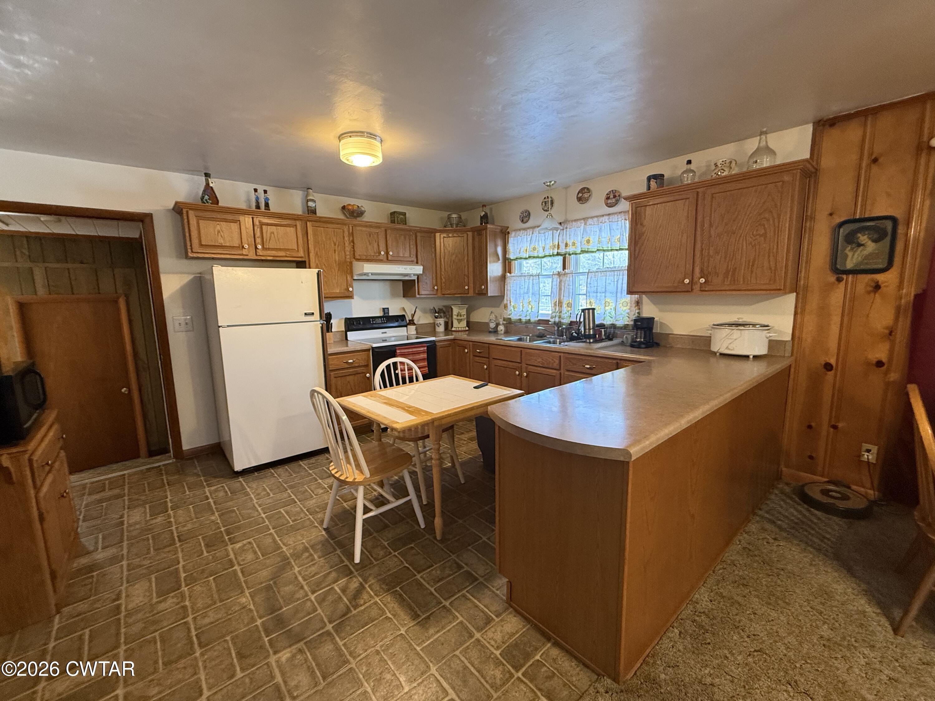 5389 Rives Mt Pelia Road Rives, TN 38253 - Photo 8 of 19 a kitchen that has a sink a table and chairs in it