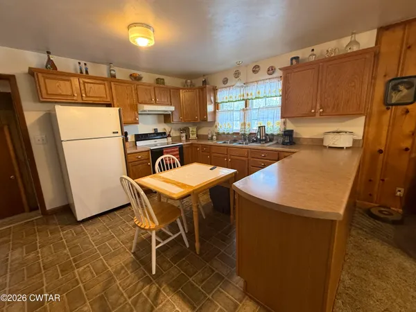 a kitchen with a refrigerator a stove a sink and dishwasher