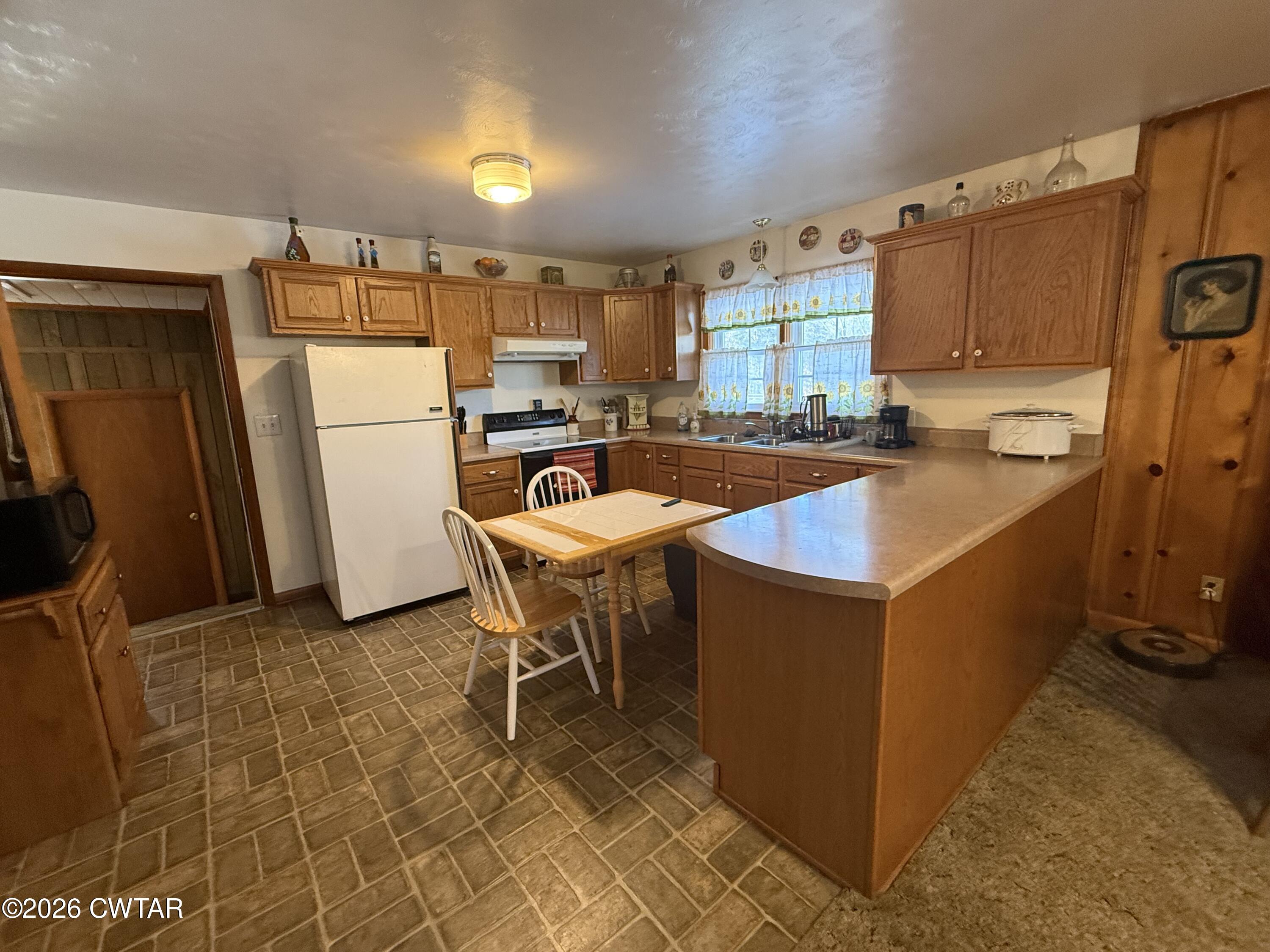 5389 Rives Mt Pelia Road Rives, TN 38253 - Photo 10 of 19 a kitchen with a sink a stove and a refrigerator