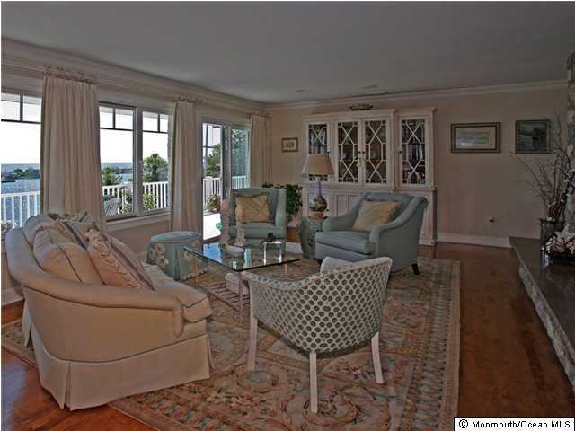 144 Portland Road Highlands, NJ 07732 - Photo 3 of 3 a living room with furniture and a floor to ceiling window