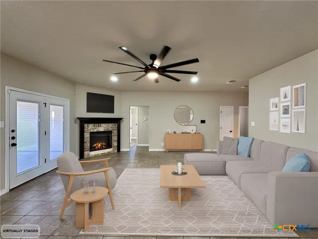 a living room with furniture and a fireplace