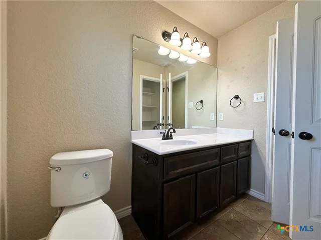 a view of an empty room and a ceiling fan