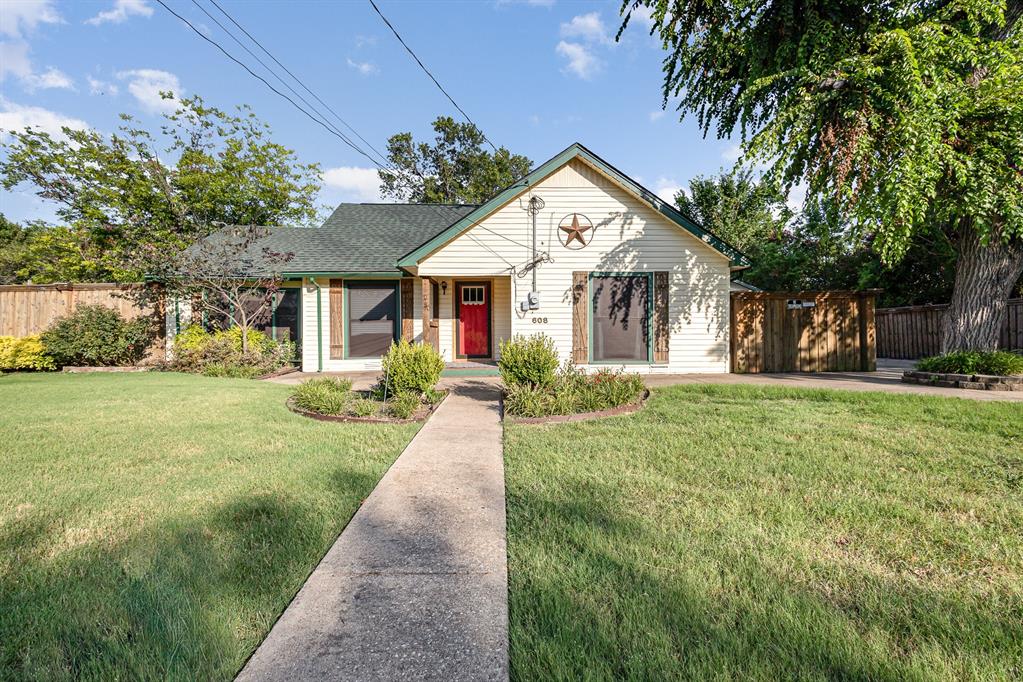 a front view of house with yard and green space