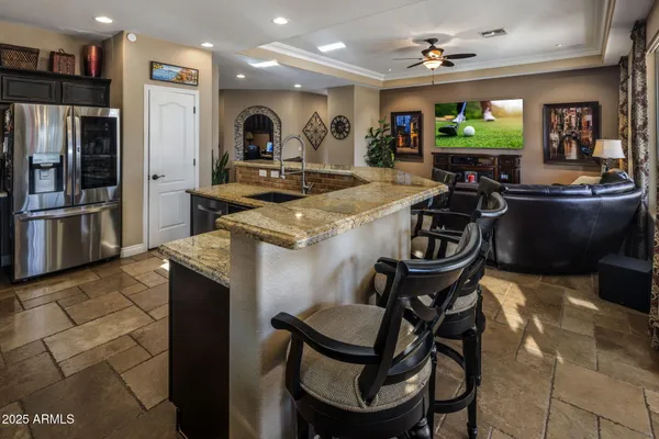 a kitchen with a stove a sink and a wooden cabinets